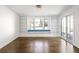 Inviting living room with custom built-in shelving, window seat, and French doors leading to the outdoors at 2025 Ash St, Denver, CO 80207