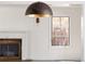 Cozy living room featuring a fireplace, a bright window view, and neutral wall colors at 2025 Ash St, Denver, CO 80207