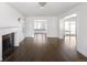 Spacious living room with fireplace and lots of natural light from the large windows and French doors at 2025 Ash St, Denver, CO 80207