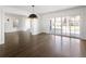 Bright living room features dark hardwood floors, white trim and walls, recessed lighting, and large glass sliding doors at 2025 Ash St, Denver, CO 80207