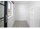 Sunlit mudroom boasts geometric tile flooring and a built-in shelving unit at 2025 Ash St, Denver, CO 80207