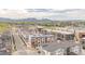Aerial view of newly built townhomes shows modern architecture, streetscape, and mountain views at 2282 Old Rail Way, Superior, CO 80027