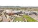 Wide aerial shot of a mixed-use community with condos, shopping, and green spaces set against a mountain backdrop at 2282 Old Rail Way, Superior, CO 80027