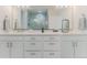 This bathroom includes a double sink vanity with quartz countertops and stainless steel hardware at 2282 Old Rail Way, Superior, CO 80027