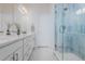 Bright bathroom features a double sink vanity, quartz countertops, and a tiled glass shower at 2282 Old Rail Way, Superior, CO 80027