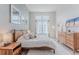 Bright primary bedroom featuring a large window, neutral decor, and wood furniture at 2282 Old Rail Way, Superior, CO 80027