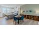 Open concept dining room adjacent to the kitchen features modern lighting and seating for four at 2282 Old Rail Way, Superior, CO 80027