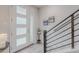 Bright entryway with a modern door, stylish staircase, and contemporary decor accents at 2282 Old Rail Way, Superior, CO 80027