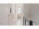 The hallway features hardwood floors, doors on either side, and black metal railing at 2282 Old Rail Way, Superior, CO 80027