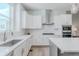This modern kitchen has white cabinets, stainless steel appliances, and sleek countertops at 2282 Old Rail Way, Superior, CO 80027