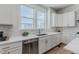 This kitchen includes stainless steel appliances, light countertops and ample natural light at 2282 Old Rail Way, Superior, CO 80027