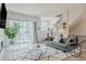 Bright living room boasts a modern sofa, contemporary decor, and seamless indoor-outdoor flow at 2282 Old Rail Way, Superior, CO 80027