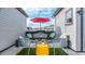 Rooftop patio with turf, a red umbrella, lounge chairs, and neighborhood views at 2282 Old Rail Way, Superior, CO 80027
