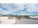 Panoramic view of mountains and cityscape from the rooftop deck, under a blue sky with scattered clouds at 2282 Old Rail Way, Superior, CO 80027