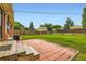 A spacious backyard features a brick patio, lush green lawn, privacy fence, and a storage shed at 11891 Gaylord Way, Northglenn, CO 80233