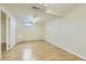Large basement area with drop ceiling, window, and hardwood flooring perfect for customizable living at 11891 Gaylord Way, Northglenn, CO 80233