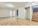 Spacious basement with hardwood flooring, neutral paint, and ample room for activities or storage at 11891 Gaylord Way, Northglenn, CO 80233