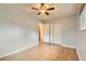 Bedroom with hardwood floors, closet space, and modern ceiling fan for comfort at 11891 Gaylord Way, Northglenn, CO 80233