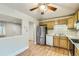 Bright kitchen featuring stainless steel appliances, light wood cabinets, and a ceiling fan at 11891 Gaylord Way, Northglenn, CO 80233