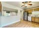 Spacious eat-in kitchen featuring wood cabinets, stainless steel fridge, and light wood flooring at 11891 Gaylord Way, Northglenn, CO 80233