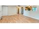 Spacious open-concept living room with hardwood floors leading to a kitchen with stainless steel appliances at 11891 Gaylord Way, Northglenn, CO 80233