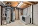 Unfinished utility room area with a furnace, water heater, and washer/dryer hookups at 11891 Gaylord Way, Northglenn, CO 80233