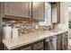 The kitchen features sleek countertops, stainless steel appliances, and a mosaic backsplash at 1324 S Niagara St, Denver, CO 80224