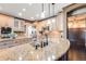 Spacious kitchen featuring granite countertops, stainless steel appliances, and pendant lighting at 2636 Trailblazer Way, Castle Rock, CO 80109