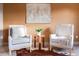 Comfortable sitting area featuring two armchairs, accent table, and calming wall art at 2636 Trailblazer Way, Castle Rock, CO 80109