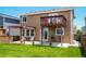 Exterior view of home's backyard featuring a deck, patio, pergola, and lawn at 9927 Aftonwood St, Highlands Ranch, CO 80126