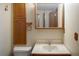 Functional bathroom with a vanity, mirror, and built-in cabinet at 9927 Aftonwood St, Highlands Ranch, CO 80126