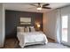 This bedroom features a ceiling fan, natural light, and stylish decor, creating a cozy and inviting atmosphere at 9927 Aftonwood St, Highlands Ranch, CO 80126
