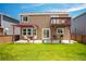 Exterior view of a two-story home with a deck, pergola, and spacious yard at 9927 Aftonwood St, Highlands Ranch, CO 80126