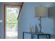 Tastefully decorated hallway featuring a stylish lamp, decorative items, and a view of the front door at 9927 Aftonwood St, Highlands Ranch, CO 80126