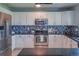 Modern kitchen with stainless steel appliances, granite countertops, and stylish backsplash at 9927 Aftonwood St, Highlands Ranch, CO 80126