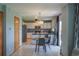 Open kitchen and dining area with stainless steel appliances, white cabinets, and a sliding glass door to the outside at 9927 Aftonwood St, Highlands Ranch, CO 80126