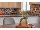 Eat-in kitchen showcasing stylish decor and modern faucet with black and white tile backsplash at 9927 Aftonwood St, Highlands Ranch, CO 80126