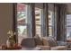 Cozy living room with large windows, patterned curtains, and comfortable seating at 9927 Aftonwood St, Highlands Ranch, CO 80126