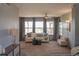 Bright living room showcasing neutral decor, a ceiling fan, large windows, and plush carpeting at 9927 Aftonwood St, Highlands Ranch, CO 80126
