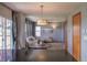 Open concept living space featuring dining table, living room, and sliding glass doors with curtains at 9927 Aftonwood St, Highlands Ranch, CO 80126