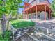 A green lawn, wooden retaining walls, a two-story deck with pergola, and a storage shed highlight the backyard space at 1674 Bent Grass Cir, Castle Rock, CO 80109