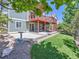 Spacious backyard featuring a well-maintained lawn, patio and a two-story deck with an attached pergola at 1674 Bent Grass Cir, Castle Rock, CO 80109