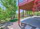 View of a landscaped backyard featuring a patio underneath a wooden deck and a lawn with mature trees at 1674 Bent Grass Cir, Castle Rock, CO 80109