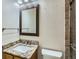 Bathroom featuring a granite vanity, a framed mirror, a toilet, and a shower with glass doors at 1674 Bent Grass Cir, Castle Rock, CO 80109