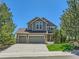 Charming two-story home boasts a three-car garage, well-maintained lawn and mature trees at 1674 Bent Grass Cir, Castle Rock, CO 80109