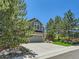Exterior view of a two-story residence showcasing a three-car garage and professionally landscaped front yard at 1674 Bent Grass Cir, Castle Rock, CO 80109