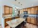 Open kitchen featuring wooden cabinets, stainless steel appliances, and a large island with seating at 1674 Bent Grass Cir, Castle Rock, CO 80109