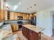 Well-lit kitchen featuring an island with granite counters, wooden cabinets, and modern appliances at 1674 Bent Grass Cir, Castle Rock, CO 80109