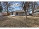 Large backyard with mature trees and covered patio at 3000 S Jackson St, Denver, CO 80210