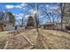 Large backyard with a shed, garden bed, and mature trees at 3000 S Jackson St, Denver, CO 80210